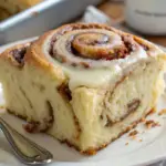 Close-up of Grandma's Cinnamon Roll Cake with a rich cinnamon swirl and cream cheese frosting