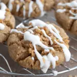 “Close-up of Keto Coffee Cake Cookies topped with cinnamon streusel and a drizzle of icing, cooling on a wire rack.”